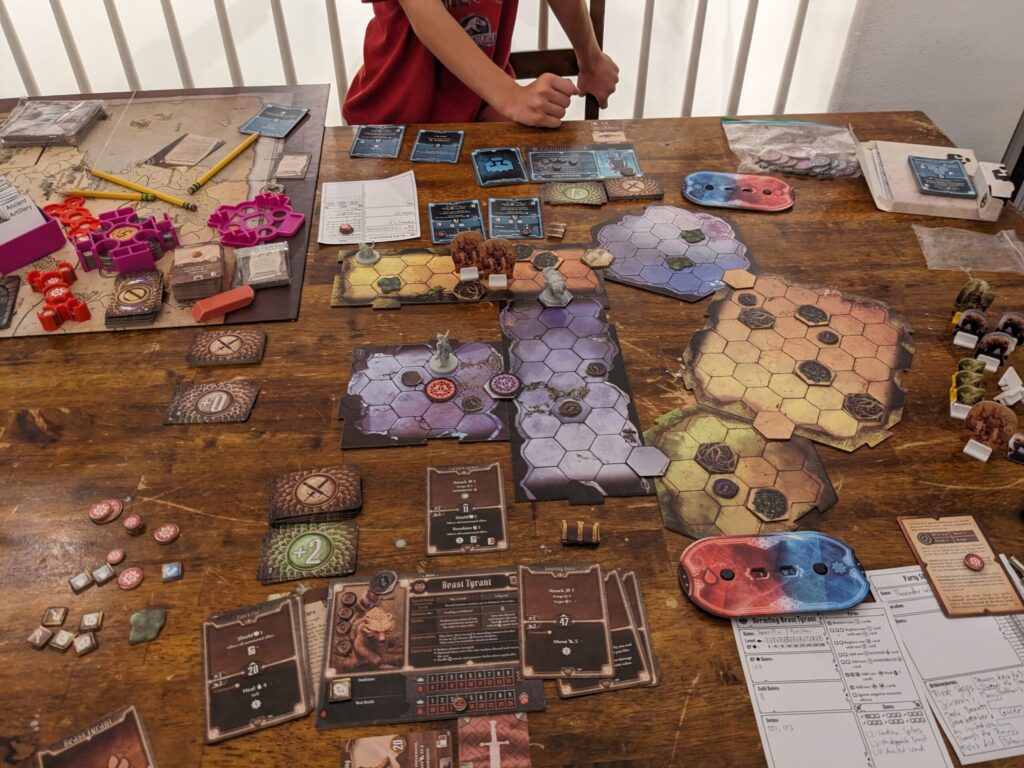 Photograph of a table set up to play the board game Gloomhaven